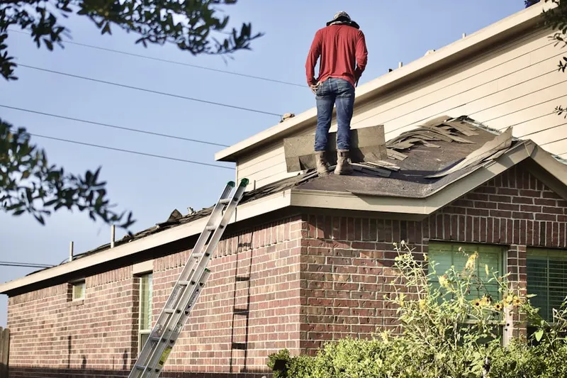 Professional roofer working on a residential roof in Neshanic Station